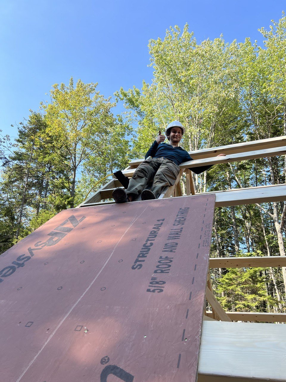 Corin on the roof installing sheathing